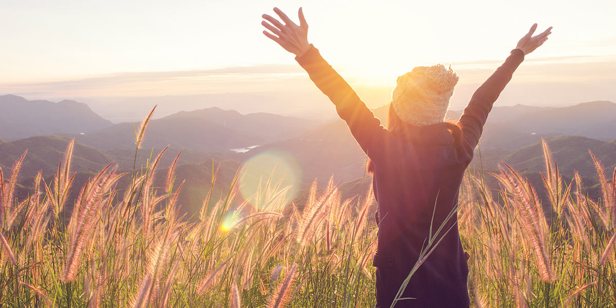 Carefree woman in meadow with financial freedom
